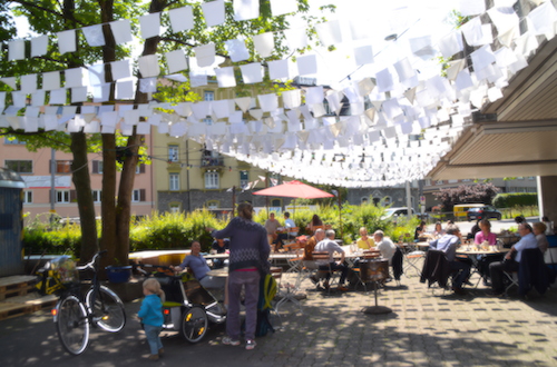 Die weissen Fähnchen machen den Platz vor dem Neubad sofort wohnlicher.